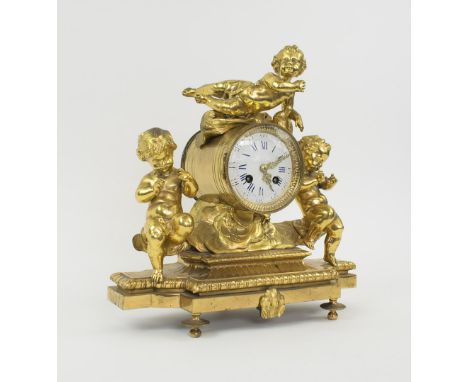 MANTEL CLOCK, late 19th/early 20th century, the gilt metal case with three putto, French bell striking movement, 33cm W x 32c