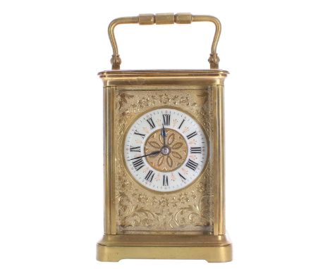 Carriage clock striking on a gong, the 2" cream enamel chapter ring enclosing a stylised floral engraved centre, within a gil