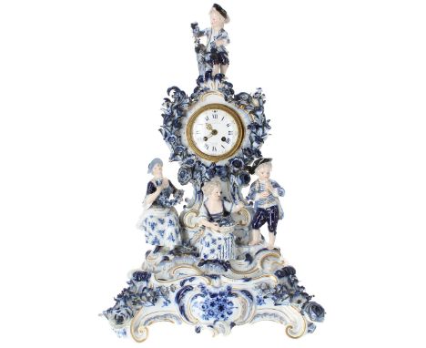 Good German blue and white porcelain figural mantel clock bearing the cross swords mark, the 2.5" white dial signed 'examined