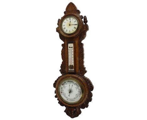 Clock and aneroid barometer with thermometer, within a foliate carved oak case, 25.5" high 