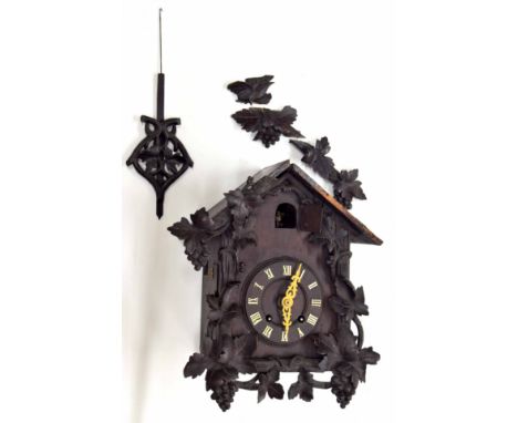 Black Forest two train cuckoo clock,&nbsp;the metal movement striking on a gong, 4.75" dial within a chalet case carved with 