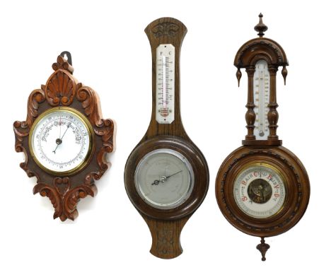 Small aneroid wall barometer, the 5" white dial within a lozenge shaped foliate carved oak case, 14" high; also two other ane