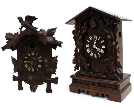 Black Forest two train cuckoo mantel clock, the 5" dial within a stepped chalet case applied with vine leaves, 18" high (pend