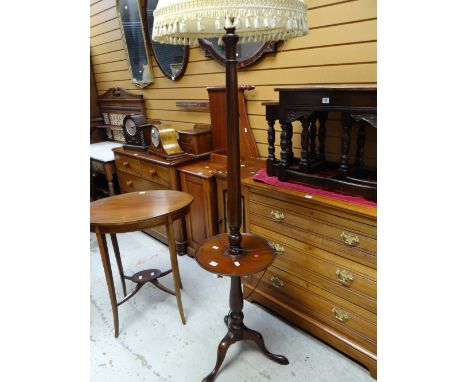 A tripod mahogany standard lamp with circular shelf