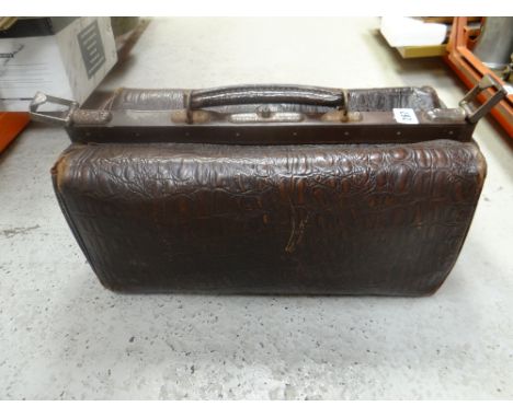 A vintage crocodile leather gladstone bag
