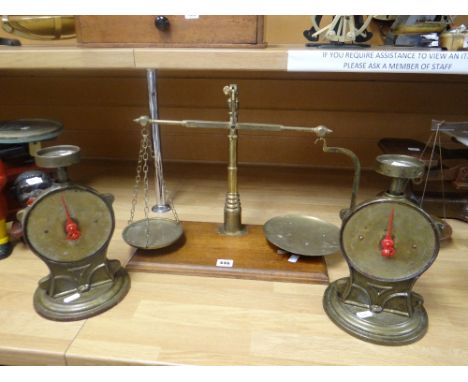 A set of brass provision scales with circular dishes on a wooden stand and together with a pair of Salters improved family sc