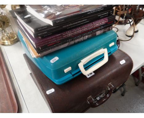 A vintage cased Imperial portable typewriter together with a portable Smith-Corona Calypso portable typewriter and a parcel o