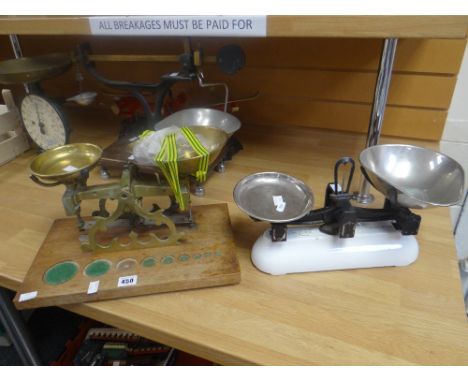 A set of vintage brass scales on a wooden stand with provision for weights, the brass mount inscribed 'C Stevens, London, Eng