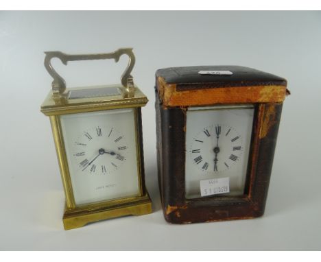 A vintage brass encased French carriage clock with outer fitted case and another later carriage clock