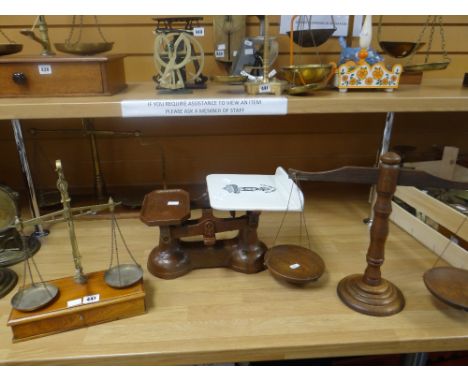 A set of turned wood balance scales, set of scales with ceramic dish and a set of balance scales on a wooden base with drawer