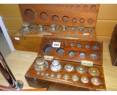 A vintage cased set of brass weights and another