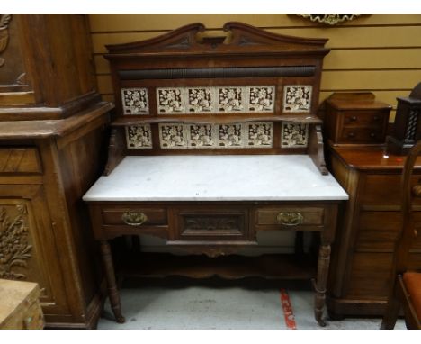 A vintage carved and tile back marble topped wash stand, 107cms wide