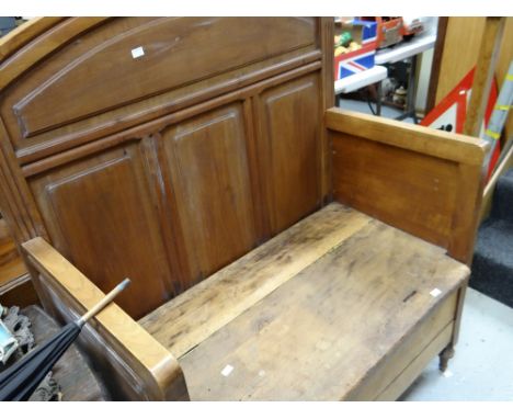 A vintage rustic lightwood panel settle