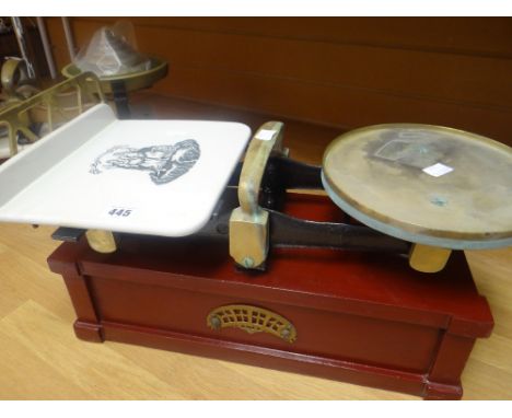 A set of vintage scales with ceramic dish bearing transfer heraldic crest on a wooden stand, 51cms wide