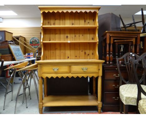 A modern pine dresser with two drawers and lower shelf and open rack, 101cms wide and a nest of three coffee tables, a narrow