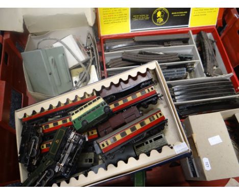 A collection of Trix Twin Railway tin-plate 00 gauge stock and two locos together with a large collection of associated build