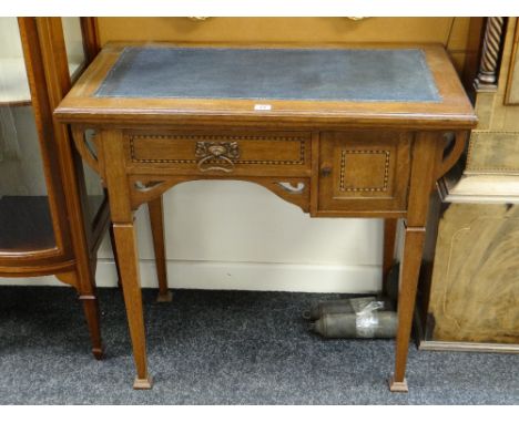 A vintage kneehole desk with marquetry detail and tooled leather top, 83cms wide