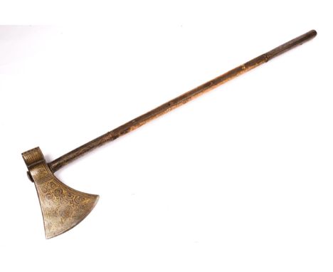An Indian axe, on 26½" steel mounted wooden haft, the head and mounts decorated with simple gold koftgari scrolls. GC, remain