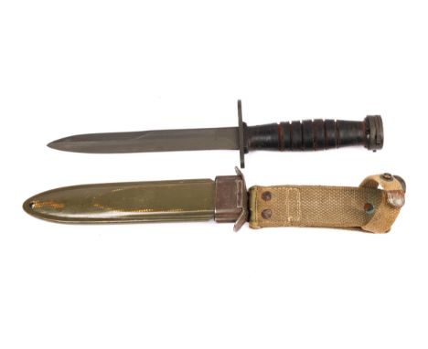 A US M4 knife bayonet for the M1 carbine, the crossguard marked "US M4 UTICA", in its fibre scabbard with webbing belt loop. 