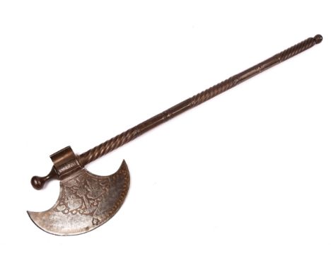A Persian all steel axe, the crescent head etched with figures seated beneath a tree, the 28½" haft decorated with spirally f