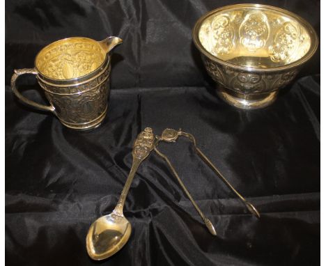 A Victorian silver sugar bowl with embossed grape and vine decoration, raised on a circular pedestal foot, bears initials "JH