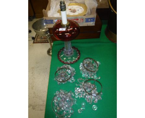 A Victorian cranberry glass and clear glass oil lamp base (converted to electricity), together with four hanging lustres