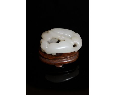 A Chinese jade carved figure of two fighting tigers on a hardwood stand   CONDITION REPORTS  To the naked eye appears in good