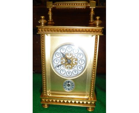 A brass cased carriage alarm clock, the silvered dial with Arabic numerals over a subsidiary dial also with Arabic numerals