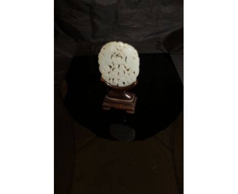A Chinese carved jade pendant depicting two phoenix, raised on a hardwood stand   CONDITION REPORTS  To the naked eye appears