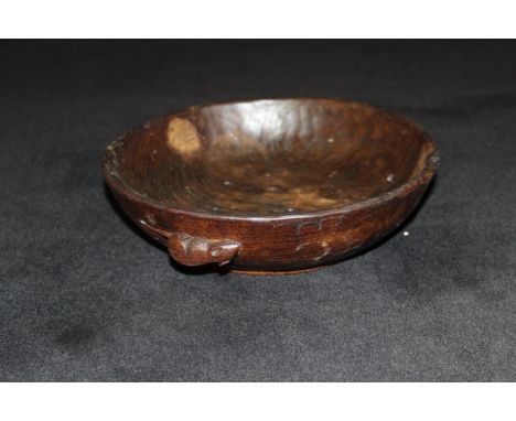 A dark oak adzed fruit bowl by Robert Thompson of Kilburn (The Mouseman) with typical mouse motif, raised on a circular foot 