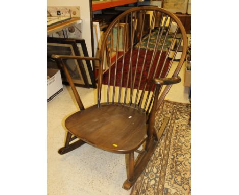 A dark elm and beech Ercol rocking chair, a pair of Lloyd Loom tub chairs and a matching stool, together with a similar stool