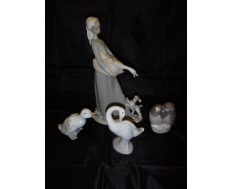 A Lladro figure of a girl with goose and spaniel, Lladro figure of goose, Nao figure of a duckling and a Royal Copenhagen fig