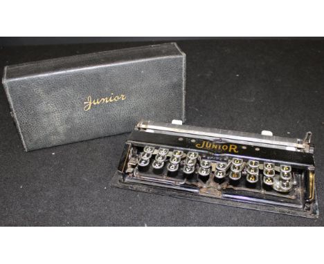 A Charles Bennett Junior Typewriter, circa 1907, by The Junior Typewriter Company, Serial No. 1044, together with a set of W 
