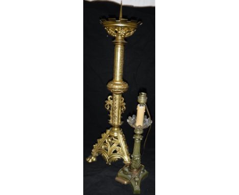 A Gothic style gilt brass pricket candlestick in the Victorian manner and an Empire style candlestick type table lamp