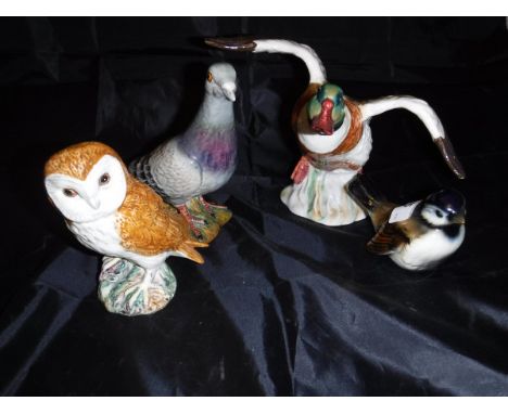 A Beswick figure "Pigeon" (1383), "Owl" (2026), "Duck alighting" (994) and a Goebel figure of "Seated bird"