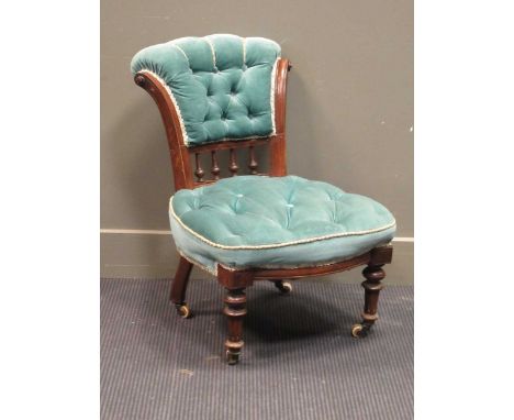 A Victorian nursing chair upholstered in green button velvet