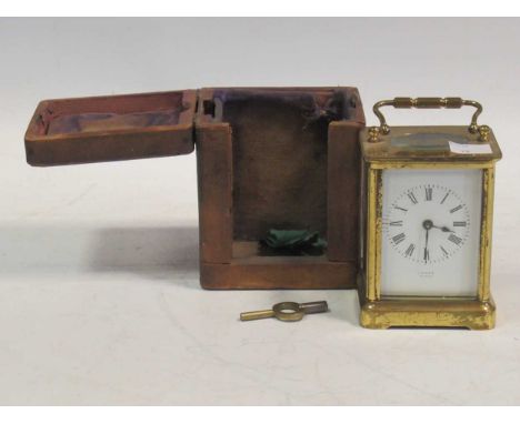 A brass carriage clock, dial inscribed 'Tain H Paris', in a travelling case
