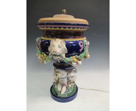 A large Minton majolica vase, moulded with garlands supported by animal heads, impressed mark, converted to a lamp, 50cm high