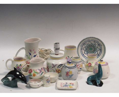 Items of Poole pottery to include a lamp, jugs and a model of a dolphin and a seal