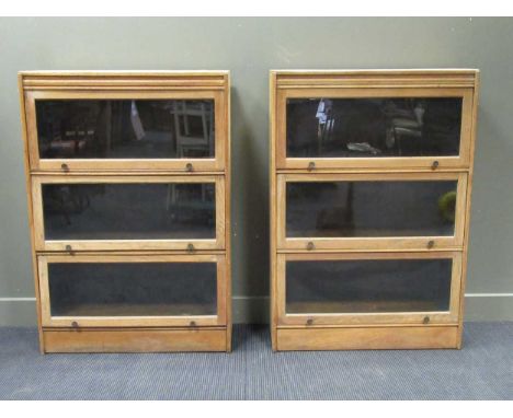 A pair of oak Globe Wernike style bookcases each with three compartments 129 x 88 x 34cm