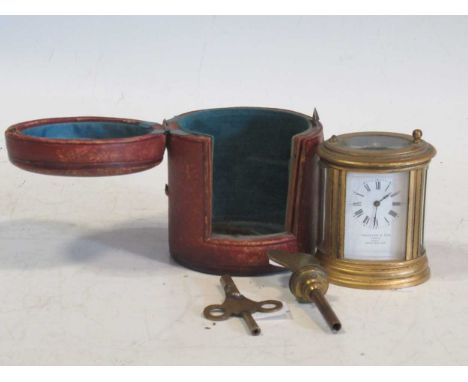 A miniature oval carriage clock (A/F), with case and associated key