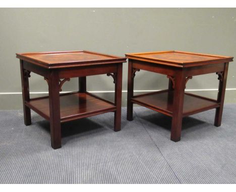 A Pair of "Charels Barr" Georgian style crossbanded flame mahogany lamp tables with undershelf and pierced spandrel decoratio