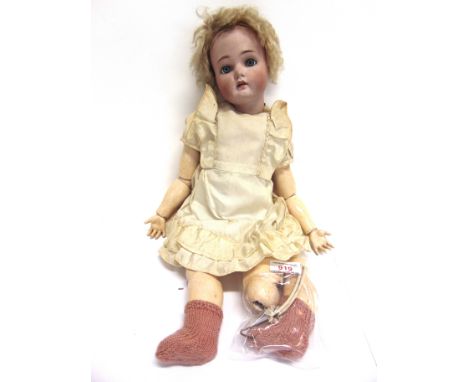 A SIMON & HALBIG FOR KAMMER & REINHARDT BISQUE SOCKET HEAD DOLL  with a cropped blonde wig, sleeping blue-grey glass eyes, pi