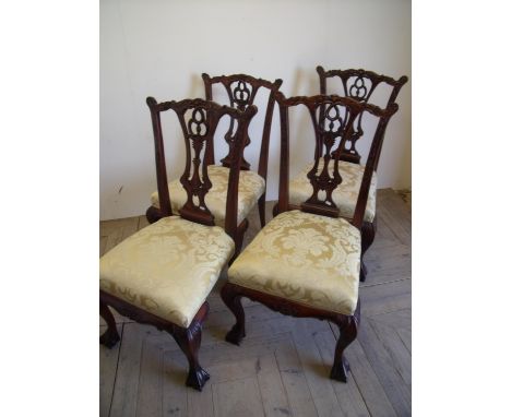 Set of four quality reproduction Chippendale style mahogany dining chairs with upholstered seats on ball & claw feet 