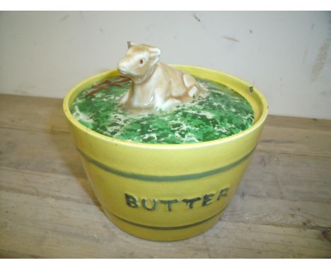 Late 19th C ceramic butter dish, the lid with seated figure of cow (diameter 14cm) (A/F) 