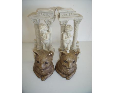 Pair of ceramic book end figures and two composite figures of decorative cupid style ornaments (4) 