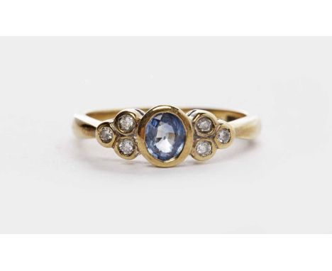 GEM AND DIAMOND RING
the central oval blue gem 4.7mm long and flanked by two groups of three round diamonds, in nine carat go