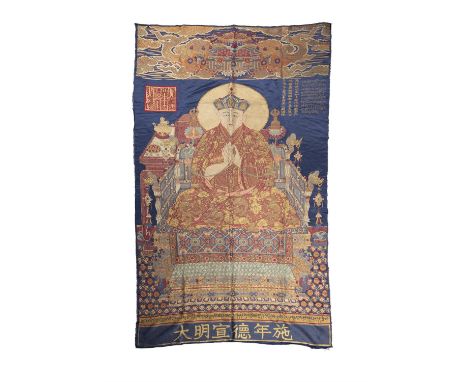A SILK BROCADE THANGKA OF THE PORTRAIT OF THE MONASTIC PATRONAGE SHAKYA YESHE WITH THREE INSCRIPTIONS IN TIBETAN AND CHINESE,
