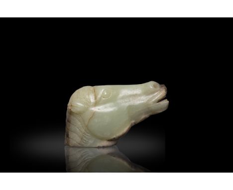 A CELADON AND RUSSET JADE HORSE HEAD明代 白玉馬首China, Ming dynastyL. 8.5cm Condition Report:  -The stone is partly calcified-Natu