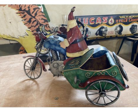 A contemporary and decorative model of Father Christmas sat on a motorcycle combination, plus a model of a Harley Davidson or